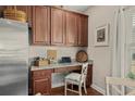 Efficient office nook with granite countertop, cabinetry, laptop, and natural light from the nearby window at 221 Shenandoah Dr., Murrells Inlet, SC 29576