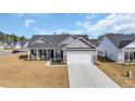 Lovely single-story home with a two-car garage, inviting front porch, and carefully landscaped yard at 252 Lakota Loop, Longs, SC 29568