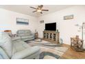 Living room with ceiling fan, hard wood floor, beach artwork, and leather sofa set at 255 Marauder Dr., Longs, SC 29568