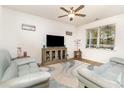 Bright living room features modern ceiling fan, recessed lights, beach artwork, and comfortable seating at 255 Marauder Dr., Longs, SC 29568