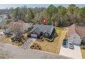 Aerial view of a single-Gathering home with a manicured lawn and two cars in the driveway at 2911 Winding River Dr., North Myrtle Beach, SC 29582