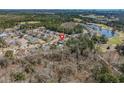 An aerial view of a single-Gathering home in a golf community surrounded by lush trees and landscaping at 2911 Winding River Dr., North Myrtle Beach, SC 29582