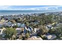 Charming neighborhood aerial view with colorful homes, lush trees, and a glimpse of the ocean at 316B Lakeside Dr., Surfside Beach, SC 29575