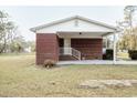 Front of brick home featuring a covered front porch and landscaped yard at 3285 Della Rd., Longs, SC 29568