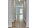 Hallway view featuring wood flooring and a neutral color scheme leading into the living area at 495 Wagner Cir., Conway, SC 29526