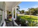 Inviting front porch with rocking chairs and lush landscaping at 595 Wilcox Ave., Murrells Inlet, SC 29576