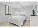 Well-lit bedroom featuring a queen bed with gray walls and a white frame and furnishings at 601 Mitchell Dr. # 203, Myrtle Beach, SC 29577