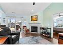 Bright living room featuring a fireplace, access to the patio, comfortable seating, and modern decor at 620 Charter Dr., Longs, SC 29568