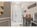 A welcoming entryway with a decorative turtle wall hanging and stylish console table with a Tequila bar set at 70 Addison Cottage Way # 121 & 32, Murrells Inlet, SC 29576
