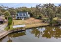 Beautiful aerial view of home with a large yard, private dock and water access at 81 Woodpecker Ln., Pawleys Island, SC 29585