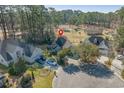 An aerial view showcases the home's location on a cul-de-sac in a wooded neighborhood at 1019 Hillsdale Dr., Little River, SC 29566