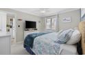 Light filled bedroom with a queen bed and coastal décor throughout at 1095 Plantation Dr. W # 27M, Little River, SC 29566