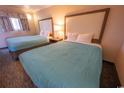 A comfortable room featuring two cozy beds, a bedside table, and soft lighting for a relaxing and peaceful ambiance at 1105 S Ocean Blvd. # 1106, Myrtle Beach, SC 29577
