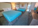 A cozy room featuring two comfortable beds, dresser and lamp that offers relaxation and convenience for a restful stay at 1105 S Ocean Blvd. # 1106, Myrtle Beach, SC 29577