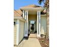 Inviting front porch featuring classic columns, stylish address display, and welcoming decor for a cozy entrance at 1501 Landfall Dr., North Myrtle Beach, SC 29582