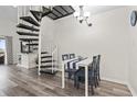 Cozy dining area features a white table, blue chairs, spiral staircase and modern decor at 1880 Auburn Ln. # 24E, Surfside Beach, SC 29575