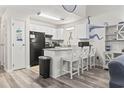 Charming kitchen featuring modern appliances, white cabinetry, bar stool seating, and beach-themed decor at 1880 Auburn Ln. # 24E, Surfside Beach, SC 29575