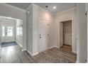 Bright foyer with hardwood flooring, white trim, with natural light and a view of the front door at 212 Sundrop Way, Conway, SC 29526