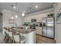Modern kitchen featuring white cabinets, stainless steel appliances, and granite countertops, with island seating at 212 Sundrop Way, Conway, SC 29526