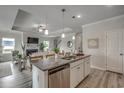 Open-concept kitchen with granite countertops, stainless steel appliances, and island seating flows to living area at 212 Sundrop Way, Conway, SC 29526