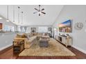 Spacious living room featuring an expansive sectional, ceiling fan, and hardwood floors at 216 Camrose Way, Myrtle Beach, SC 29579