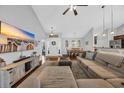 Open-concept living room showcasing hardwood floors, a large sectional, and modern decor at 216 Camrose Way, Myrtle Beach, SC 29579