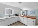 Spacious kitchen with bright lighting, white cabinets, and view to living area at 406 47Th Ave. S, North Myrtle Beach, SC 29582