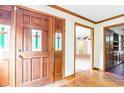 Inviting foyer with stained glass detailing in the front door and beautiful wood flooring and trim at 438 Aspen Loop, Pawleys Island, SC 29585