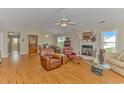 Spacious living room with a cozy fireplace, ceiling fans, and lots of natural light at 441 Plymouth Loop, Longs, SC 29568