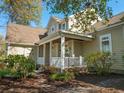 Inviting front porch, with white railing and columns, leads to the entrance of this attractive home at 4966 S Island Dr. S, North Myrtle Beach, SC 29582