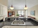 Updated kitchen with granite countertops overlooking the dining and living area at 601 Hillside Dr. N # 4535, North Myrtle Beach, SC 29582