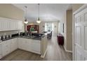 Bright kitchen featuring white cabinets, granite countertops, and stainless steel dishwasher open to the dining area at 601 Hillside Dr. N # 4535, North Myrtle Beach, SC 29582