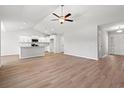 Spacious open-concept living area with wood-look flooring, modern ceiling fan, and ample natural light at 632 Woodside Dr., Conway, SC 29526