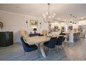 Elegant dining room featuring a large wooden table, stylish seating, and a modern chandelier, perfect for Gathering gatherings at 780 Old Murrells Inlet Rd., Murrells Inlet, SC 29576