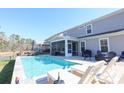Inviting backyard pool area with lounge chairs, screened porch, perfect for relaxation and entertaining at 780 Old Murrells Inlet Rd., Murrells Inlet, SC 29576