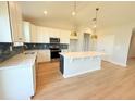 Spacious kitchen with white cabinets, a large island, and stainless steel appliances at 8628 Farrier Dr., Myrtle Beach, SC 29588