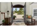 Spacious foyer with hardwood floors and decorative entry doors offers a warm welcome at 9785 Anchor Dr., Longs, SC 29568