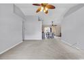 Bright living room with neutral carpet, ceiling fan, and open access to the dining area, perfect for entertaining at 1336 Gailard Dr., Conway, SC 29526