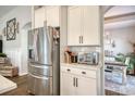 Bright kitchen featuring stainless steel appliances and white cabinets, complemented by an arched entryway to the dining area at 1439 Castleberry Pl., Myrtle Beach, SC 29588