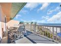 Outdoor seating on a covered balcony overlooking the beach at 145 South Dunes Dr. # 503, Pawleys Island, SC 29585