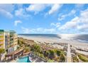 Beachfront building featuring a pool, boardwalk and ocean views at 145 South Dunes Dr. # 503, Pawleys Island, SC 29585