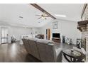 Spacious living room showcasing vaulted ceilings, hardwood floors, brick fireplace, and comfortable seating area at 1463 Gibson Ave., Surfside Beach, SC 29575
