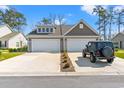 Attractive townhome with a two-car garage, and a private driveway, offering ample parking at 1586 Jardine Loop, Little River, SC 29566