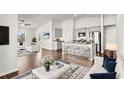 Open-concept living room showcasing modern décor, hardwood floors, and ample natural light at 1586 Jardine Loop, Little River, SC 29566