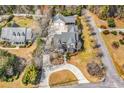 Expansive aerial view of the property showcasing the home, guest house, circular driveway, and lush surroundings at 182 Duck Blind Trail, Myrtle Beach, SC 29588