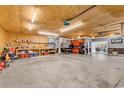 Spacious garage with ample workspace, custom shelving, and a view of the lanai at 182 Duck Blind Trail, Myrtle Beach, SC 29588