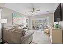 Comfortable living room with large sectional couch, ceiling fan, and sliding glass doors with scenic water views at 2180 Waterview Dr. # 713, North Myrtle Beach, SC 29582
