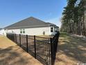 View of the home's backyard, enclosed by a black metal fence at 2441 Capri Court, Conway, SC 29527