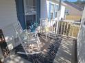 Inviting front porch with rocking chairs, patterned rug, and cheerful decor for relaxing outdoor seating at 2516 Stones Edge Blvd., Little River, SC 29566