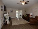 Cozy living room with a comfortable sofa, plush rug, and access to the screened porch at 2516 Stones Edge Blvd., Little River, SC 29566